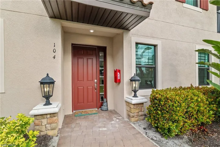 Entrance to property with stucco siding