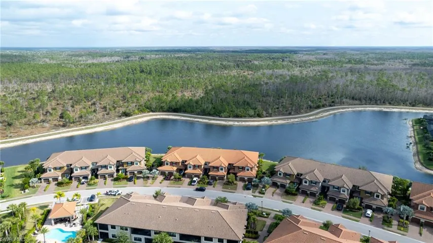 Aerial view of a nearby body of water and a heavily wooded area