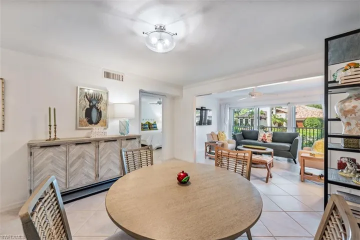 Tiled dining space with crown molding