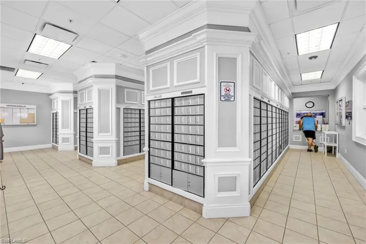 View of home's community featuring a drop ceiling, mail area, and crown molding