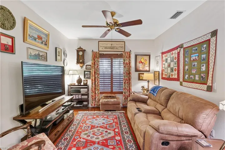 Living room featuring ceiling fan and hardwood / wood-style floors