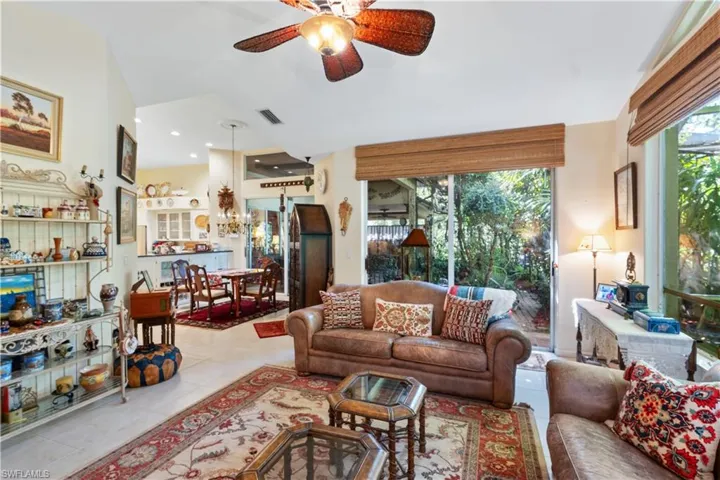 Living room featuring tile floors and ceiling fan