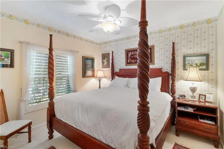 Carpeted bedroom with ceiling fan