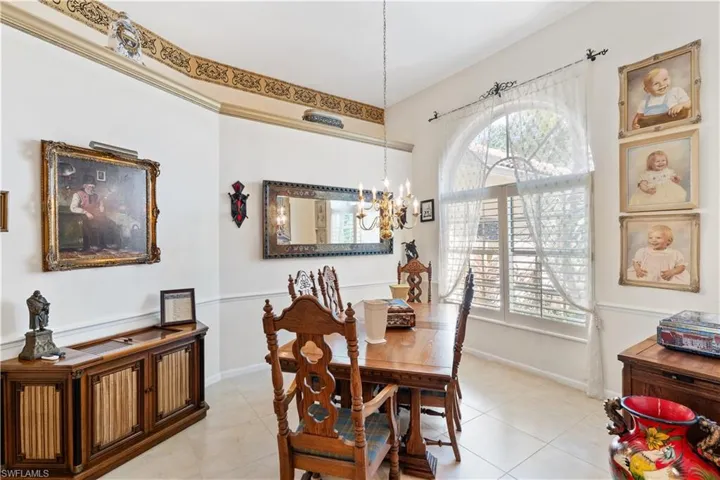 Tiled dining room with an inviting chandelier