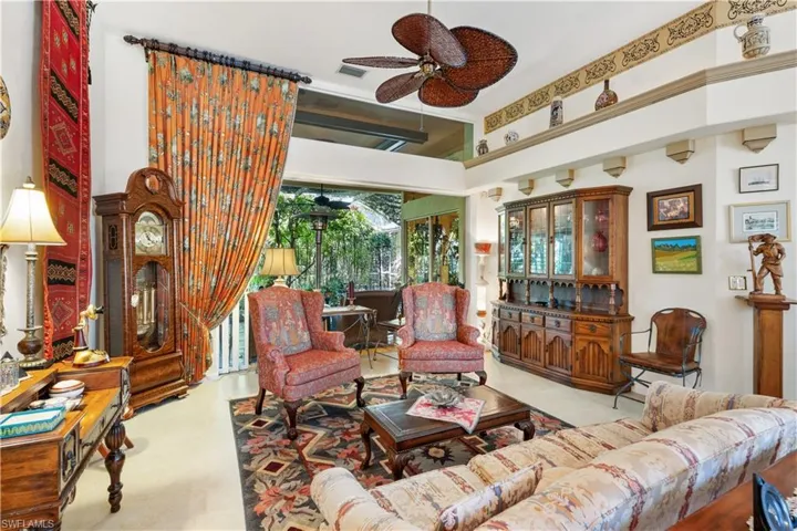 Living room featuring a towering ceiling and ceiling fan
