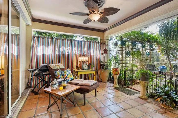 Sunroom / solarium featuring a healthy amount of sunlight and ceiling fan