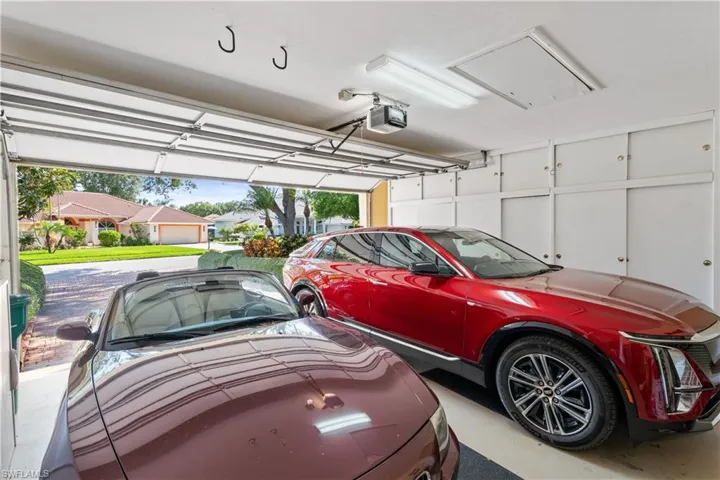 Garage featuring a garage door opener and a carport