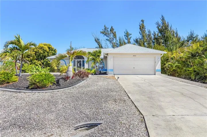 Single story home with concrete driveway, an attached garage, and stucco siding