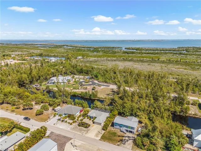 Aerial perspective of suburban area featuring a nearby body of water