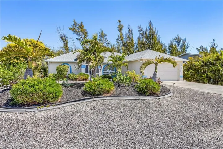 Single story home with a garage, driveway, and stucco siding