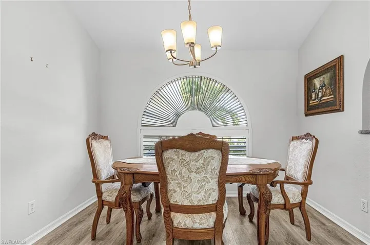Dining area featuring light wood-style floors and suspended lighting