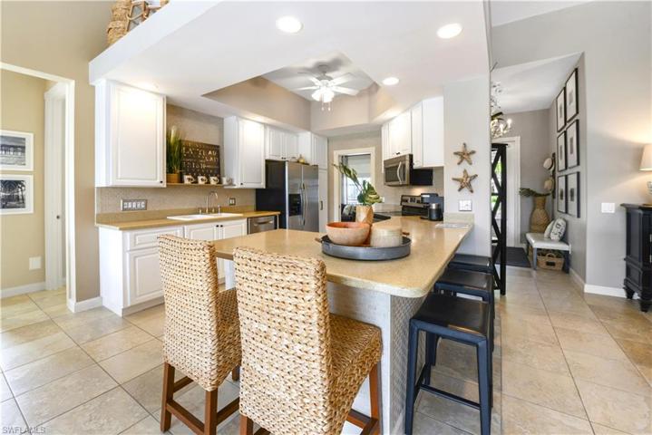 The Kitchen Comes With Stainless Steel Appliances, Tile Backsplash, Solid Surface Countertops, Custom White Cabinets And Drawers With New Pulls, A Breakfast Bar That Seats Five Comfortably, And A Ceiling To Floor Pantry!