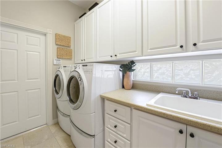 The Laundry Room Comes With Front Load Washer And Dryer On Pedestals, Extra Cabinet Storage, And A Laundry Sink!