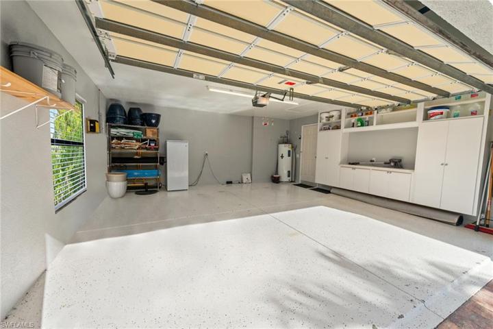 The Epoxy Coated Garage Has Plenty Of Extra Storage For Both Cars And Golf Carts!