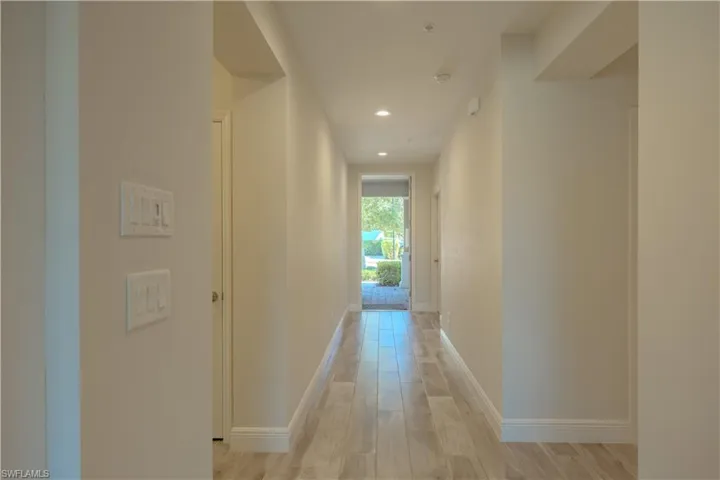 Hallway with recessed lighting and light wood-type flooring