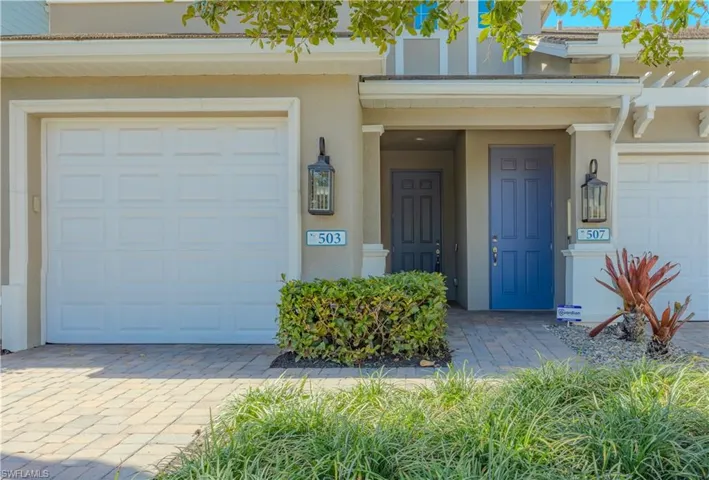 Entrance to property featuring stucco siding and a garage