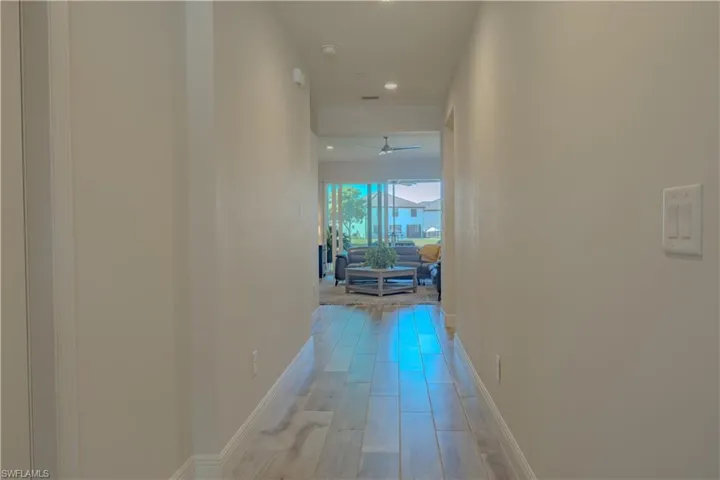 Corridor featuring light wood-style flooring and recessed lighting