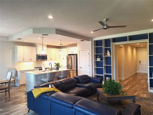 Living area featuring light wood-style floors, recessed lighting, and a ceiling fan
