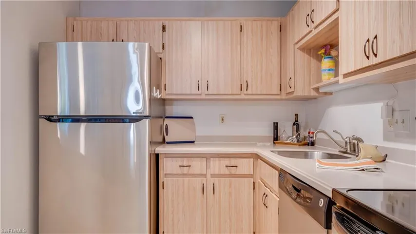 Light toned cabinetry, glistening appliances, and spotless countertops.