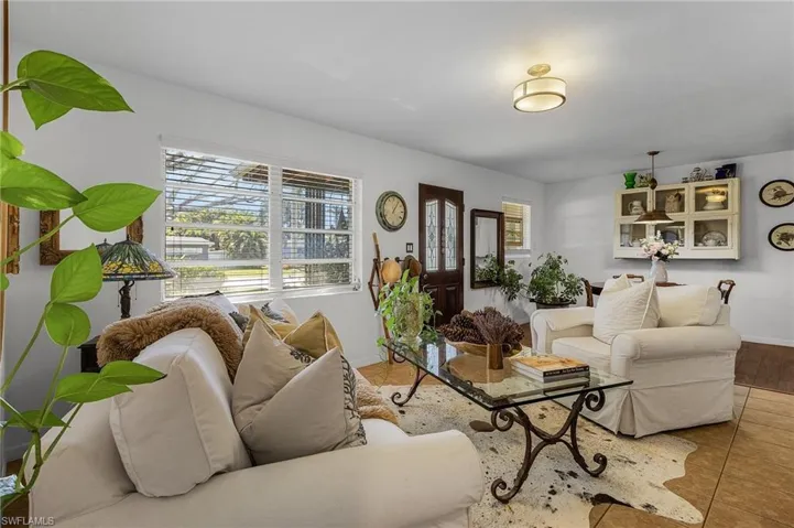 Tiled living room featuring baseboards