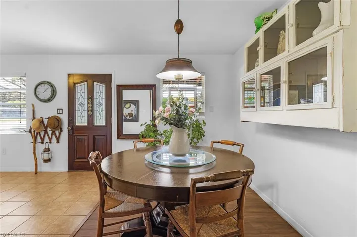 Dining area with baseboards and light tile patterned flooring