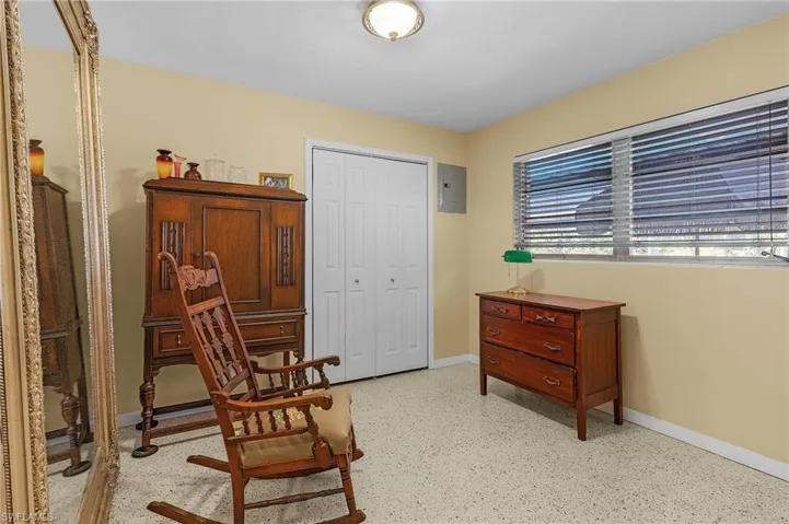 Living area with electric panel and baseboards