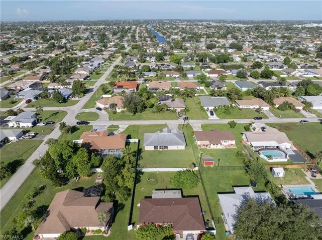 Aerial view of property's location with nearby suburban area