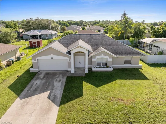 Ranch-style home with stucco siding, a shingled roof, driveway, a residential view, and an attached garage