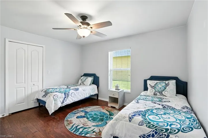 Guest bedroom 2 with walk in closet and ceiling fan