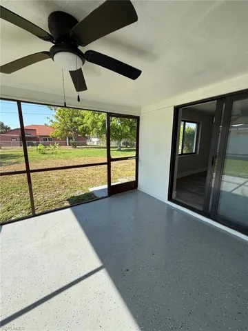 Unfurnished sunroom featuring a ceiling fan