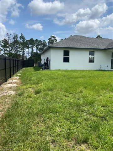 View of yard featuring fence
