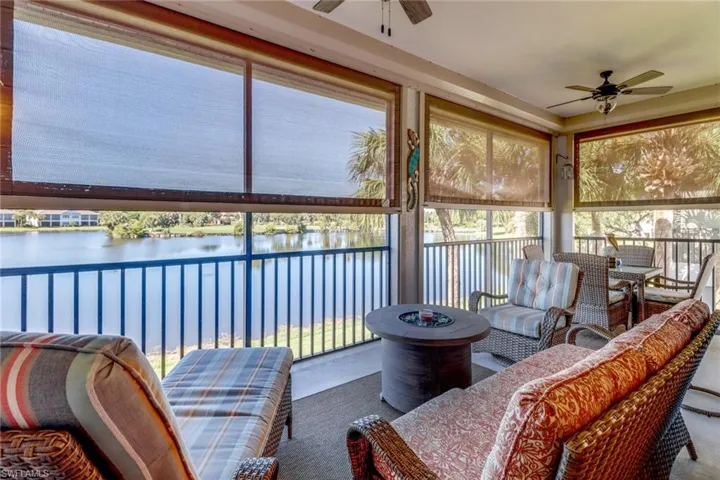 Sunroom / solarium with a water view and ceiling fan
