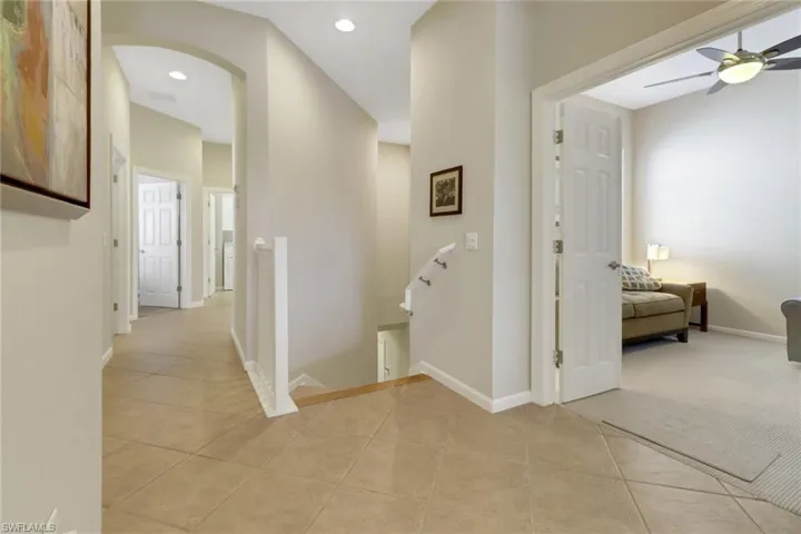 Hall featuring light tile patterned flooring