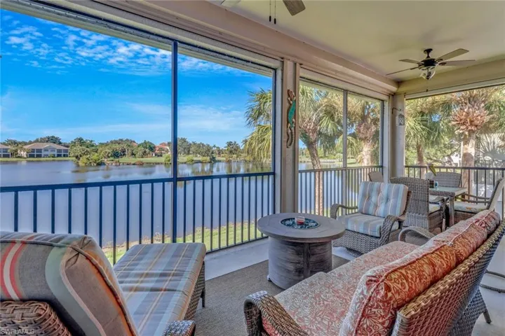 Sunroom featuring ceiling fan and a water view