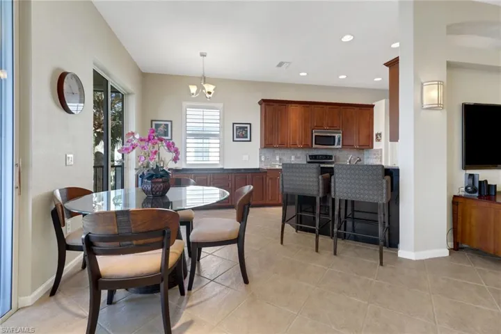 Dining room with a chandelier and light tile patterned floors