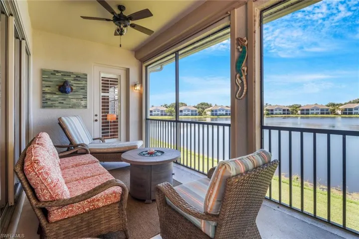 Sunroom with a water view and ceiling fan