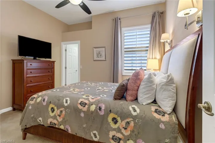 Bedroom featuring ceiling fan and light carpet