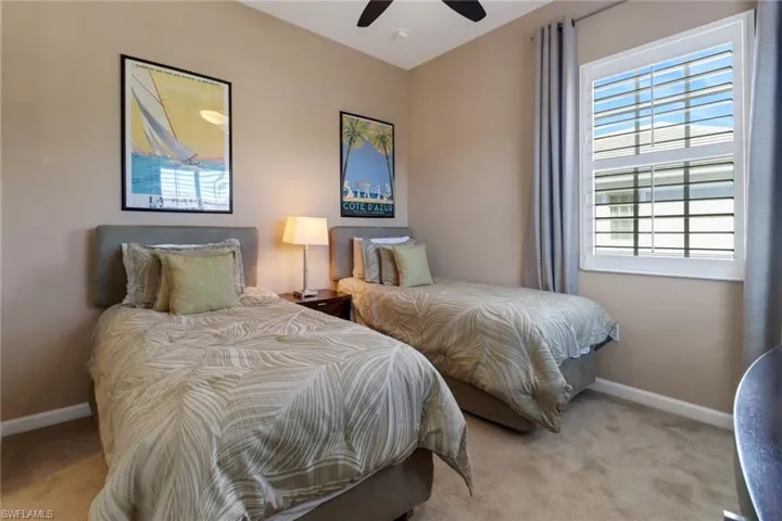 Carpeted bedroom with ceiling fan