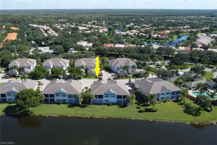 Birds eye view of property with a water view