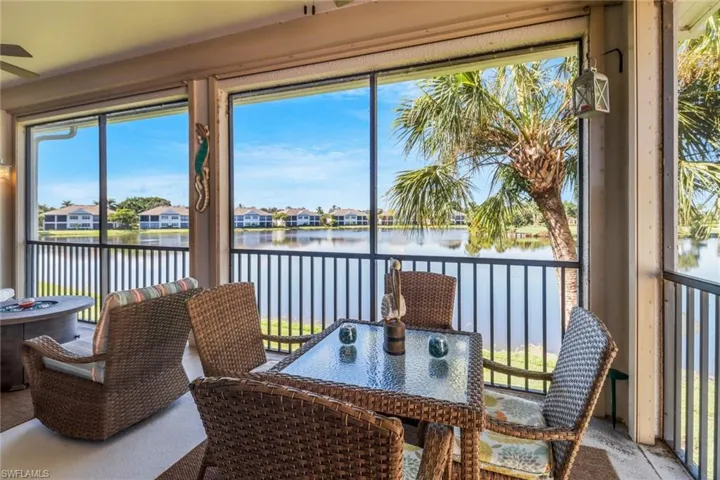 Sunroom / solarium with a healthy amount of sunlight, a water view, and ceiling fan