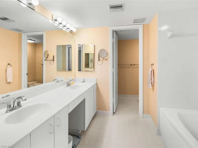 Master bath offers dual sinks, whirlpool tub, separate shower, private toilet