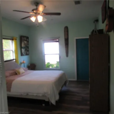 Bedroom featuring ceiling fan and dark hardwood / wood-style floors