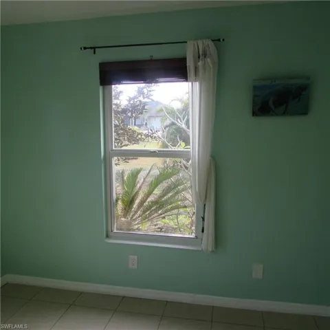 Spare room with tile patterned flooring