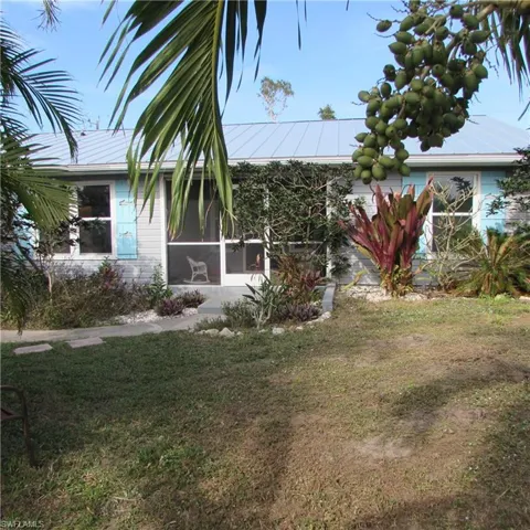View of yard with a sunroom