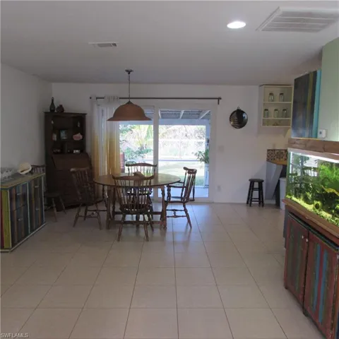 Dining room with light tile patterned flooring