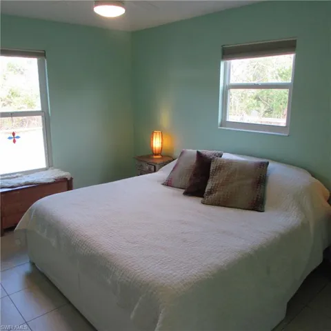 Tiled bedroom with ceiling fan