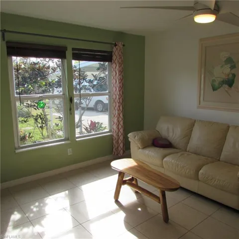 Living room featuring a healthy amount of sunlight and light tile patterned flooring