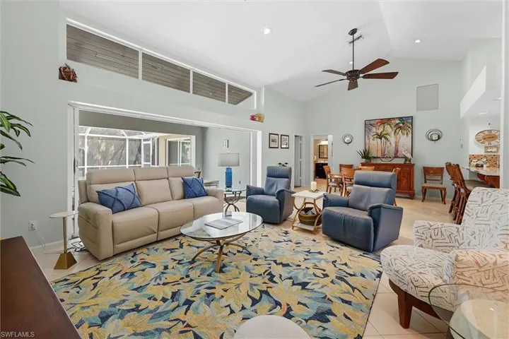 Vaulted ceilings, transom windows, recessed lighting, ceiling fan, and tile flooring
