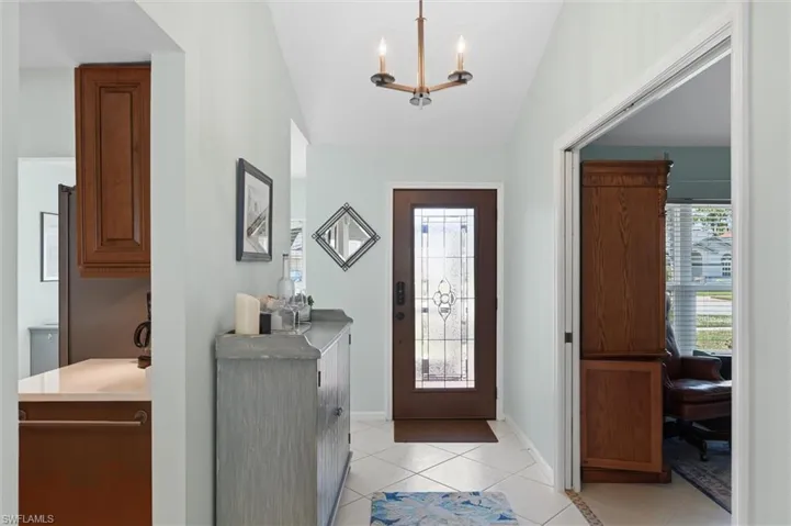 Entryway featuring a decorative glass door, tiled flooring, and a ceiling-mounted light fixture