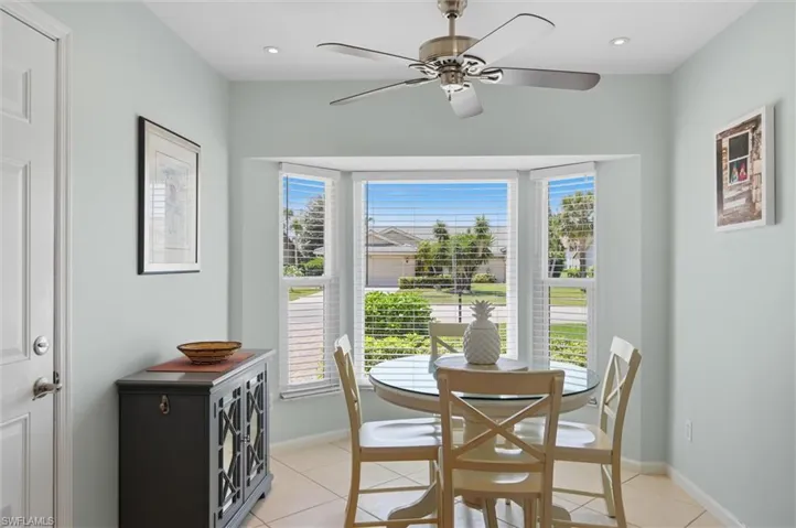 Bay window with white blinds, recessed lighting, and a ceiling fan